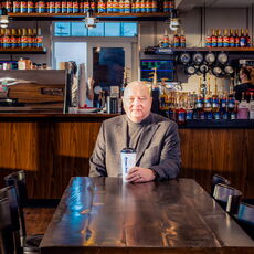Loren Goodridge seated in an Aroma Joe's coffee house