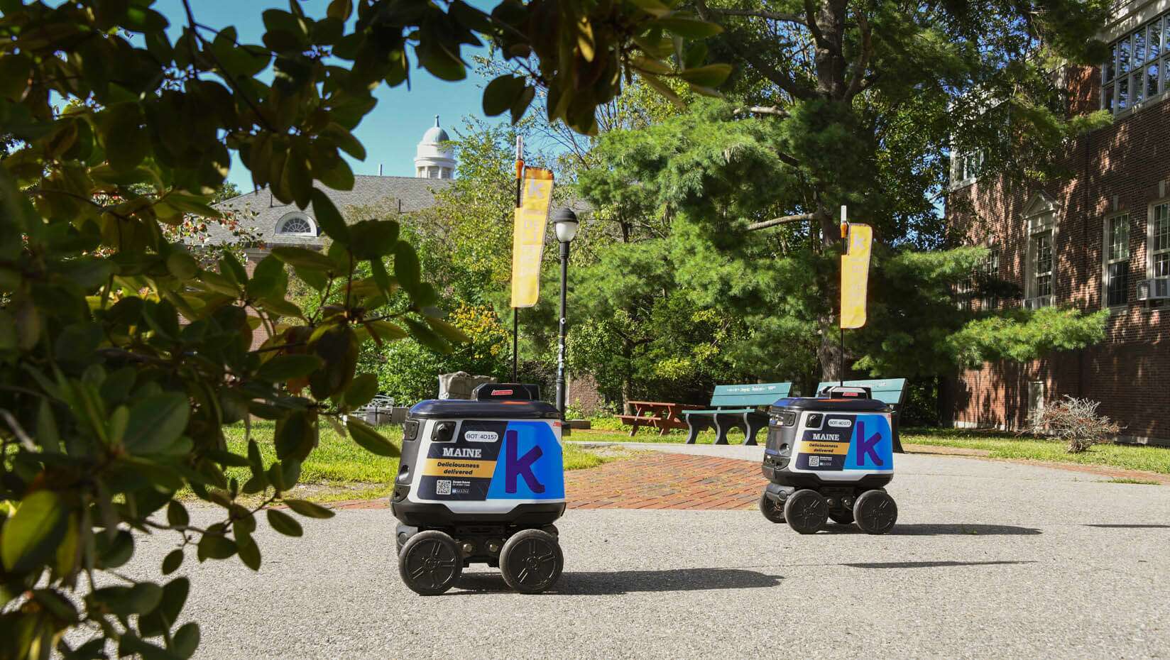2 small robots on college campus
