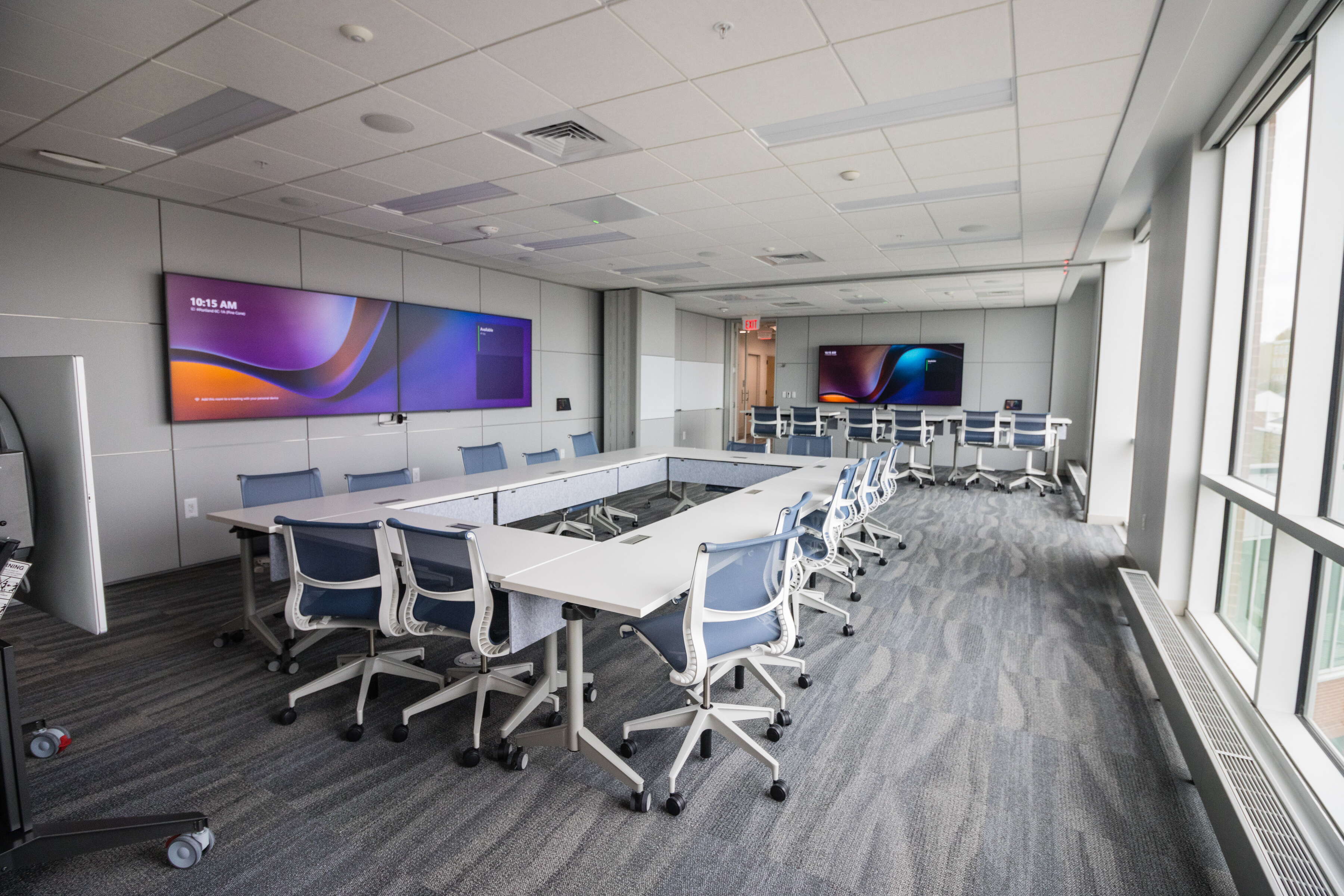 conference rooms with tables, chairs and screens