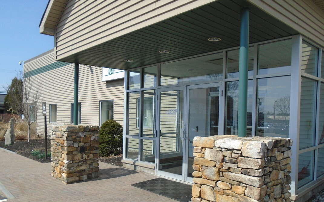 entry with glass doors and rock pillars