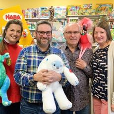 two couples standing with toys