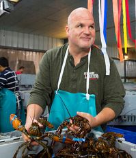 person in apron with lobster