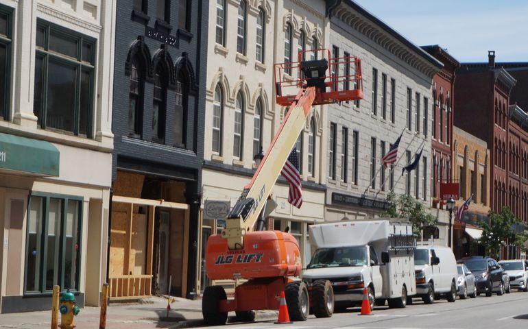 a crane in front of a row of victorian era downtown buildlings in Augusta Maine