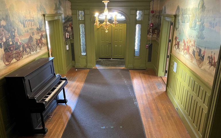 wallpaper and piano in entryway