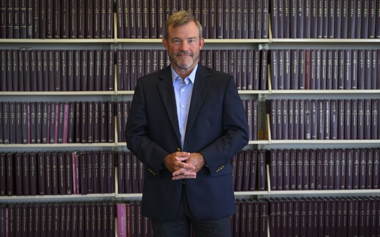 Scott Anderson standing in front of law books