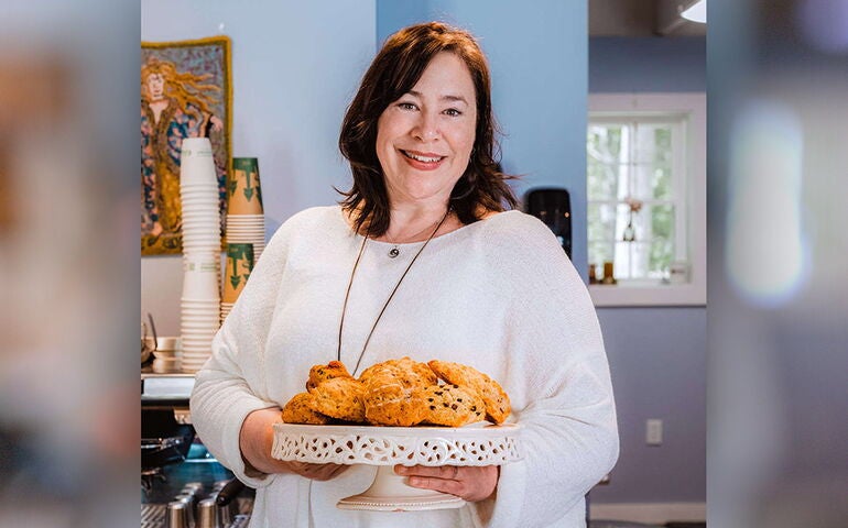 Woman holding a platter of scones 