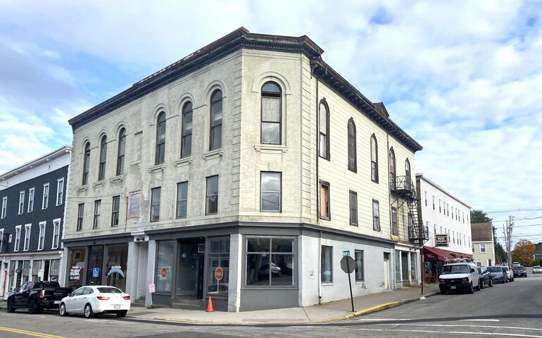 street corner view of four-story building