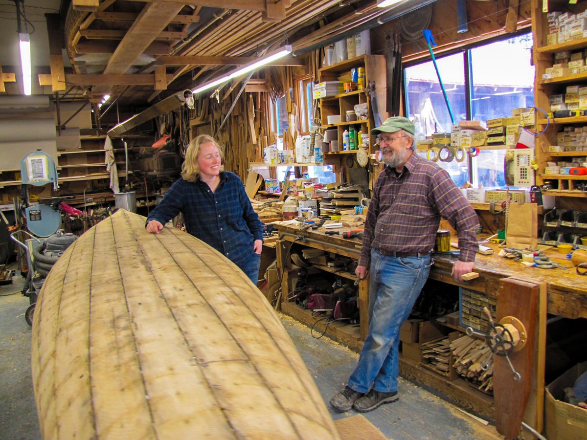 PHOTO / PETER VAN ALLEN Elisa Schine, a canoe builder at Northwoods Canoe Co., called up Rollin Thurlow, right, for an internship and has now been there seven years.
