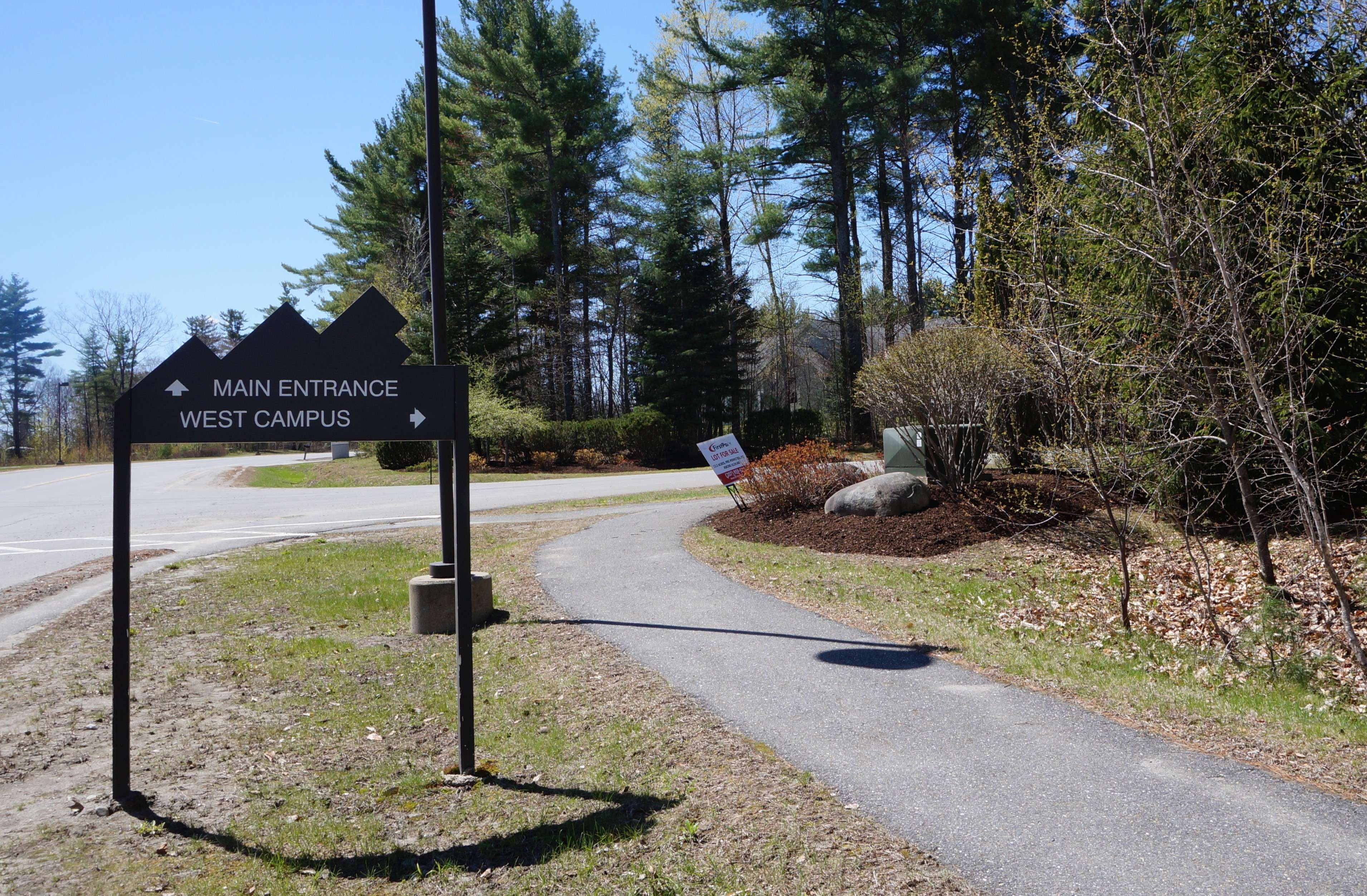 wooded lot with for sale sign