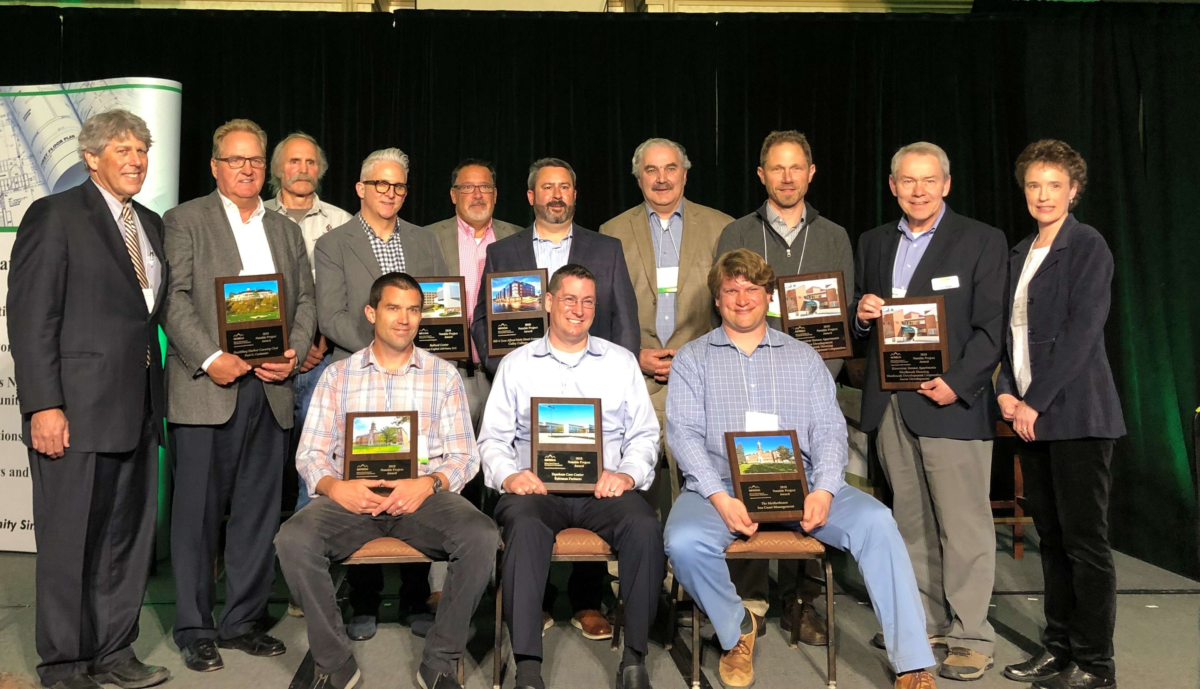 Men holding plaques