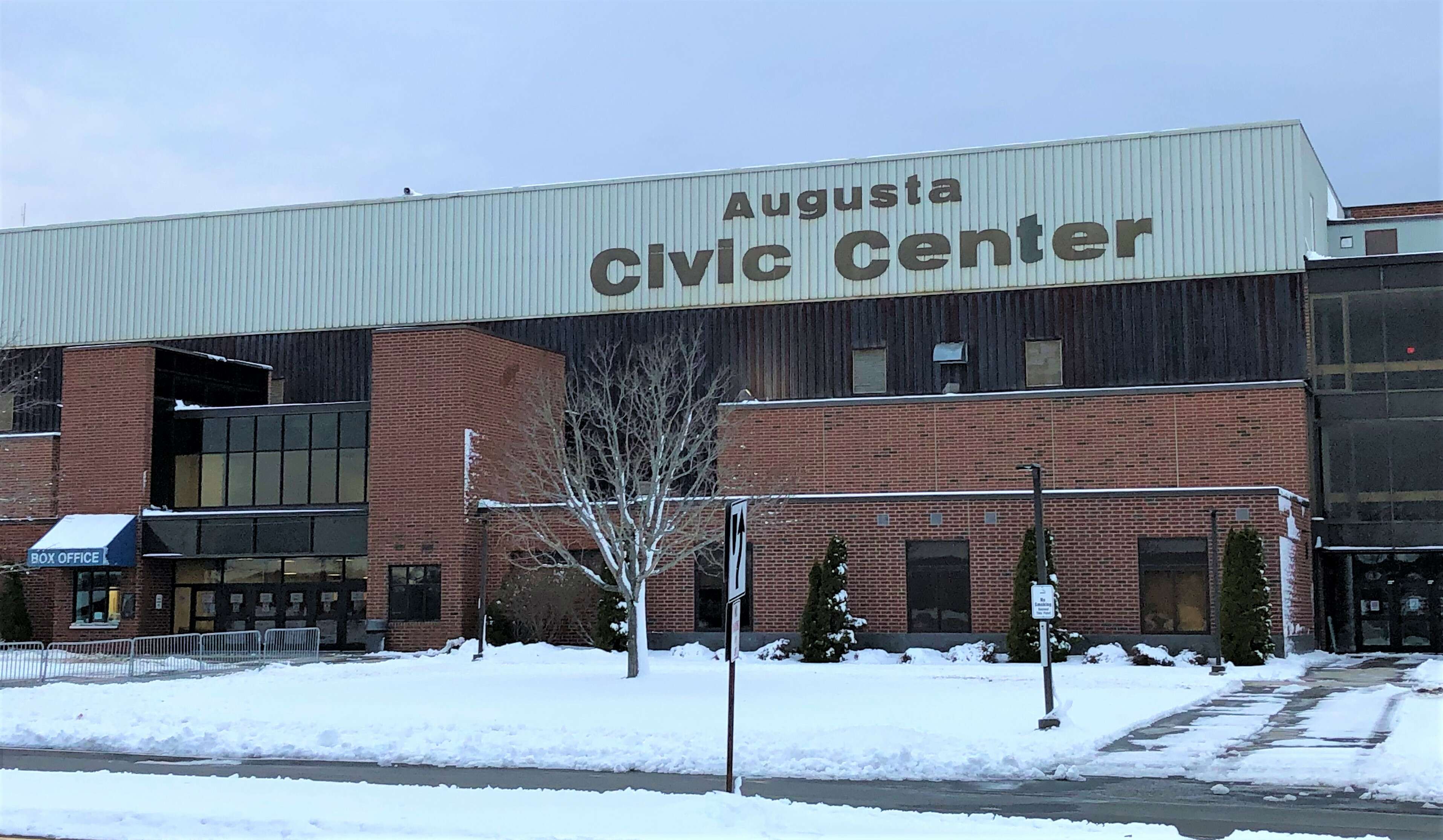 a large brick building with snow in the front and Augusta Civic Center in large letters near the roof