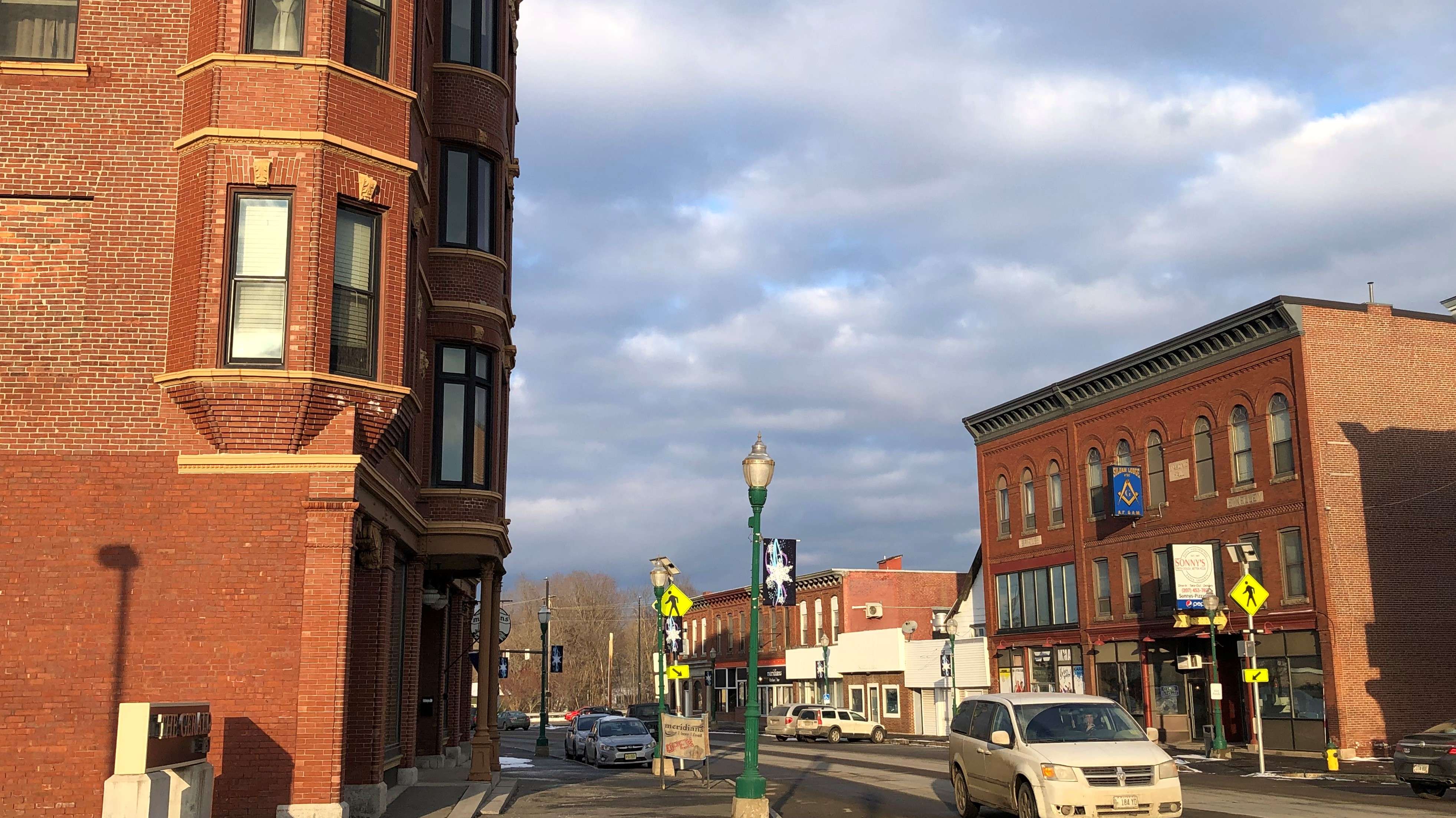 A small downtown with two and three story brick buildings