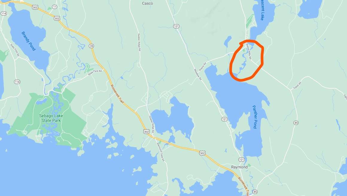 a map showing Sebago Lake in the lower lefthand corner, a variety of lakes and ponds and U.S. Route 202, above that, in the upper right, a small, crooked river runs between Crescent and Palmer ponds, and is circled in orange.