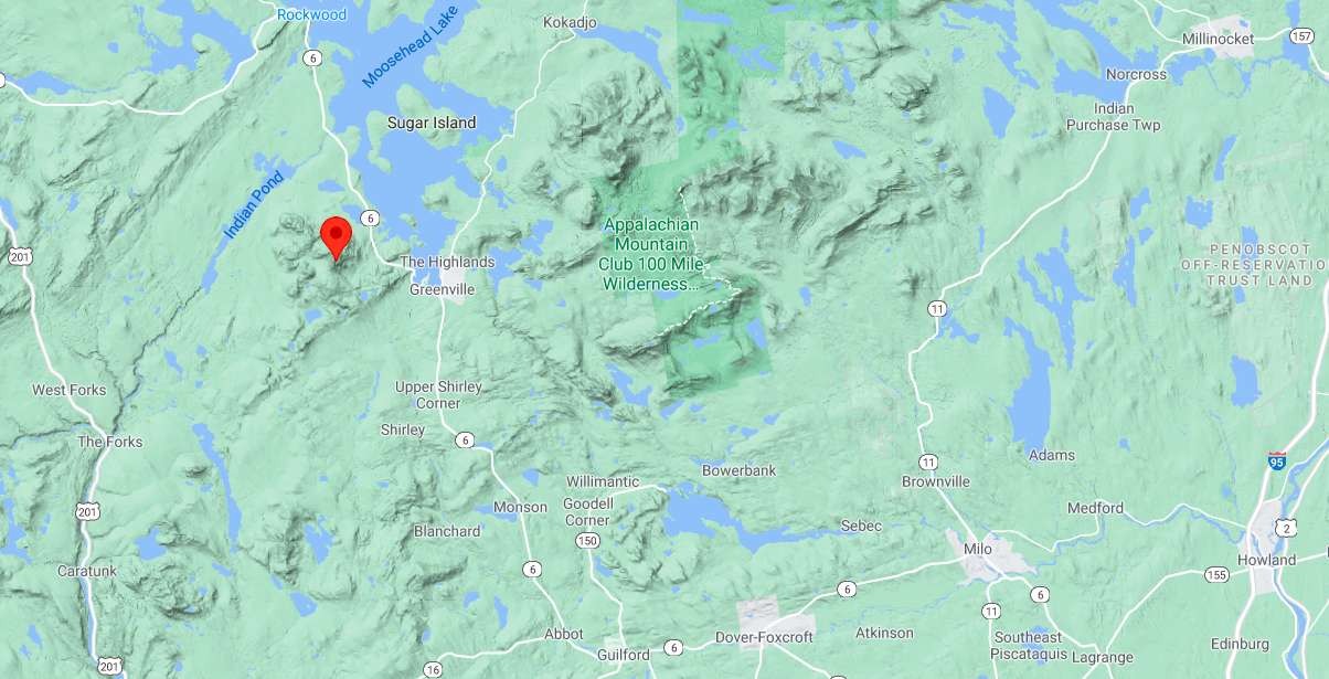 a terrain map shows a location marker on a mountain that is northwest of greenville next to Moosehead Lake