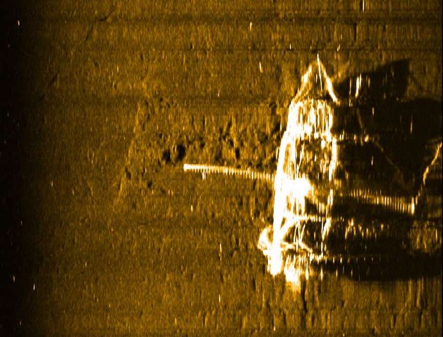 Grainy image of fishing boat, viewed from above, on ocean floor