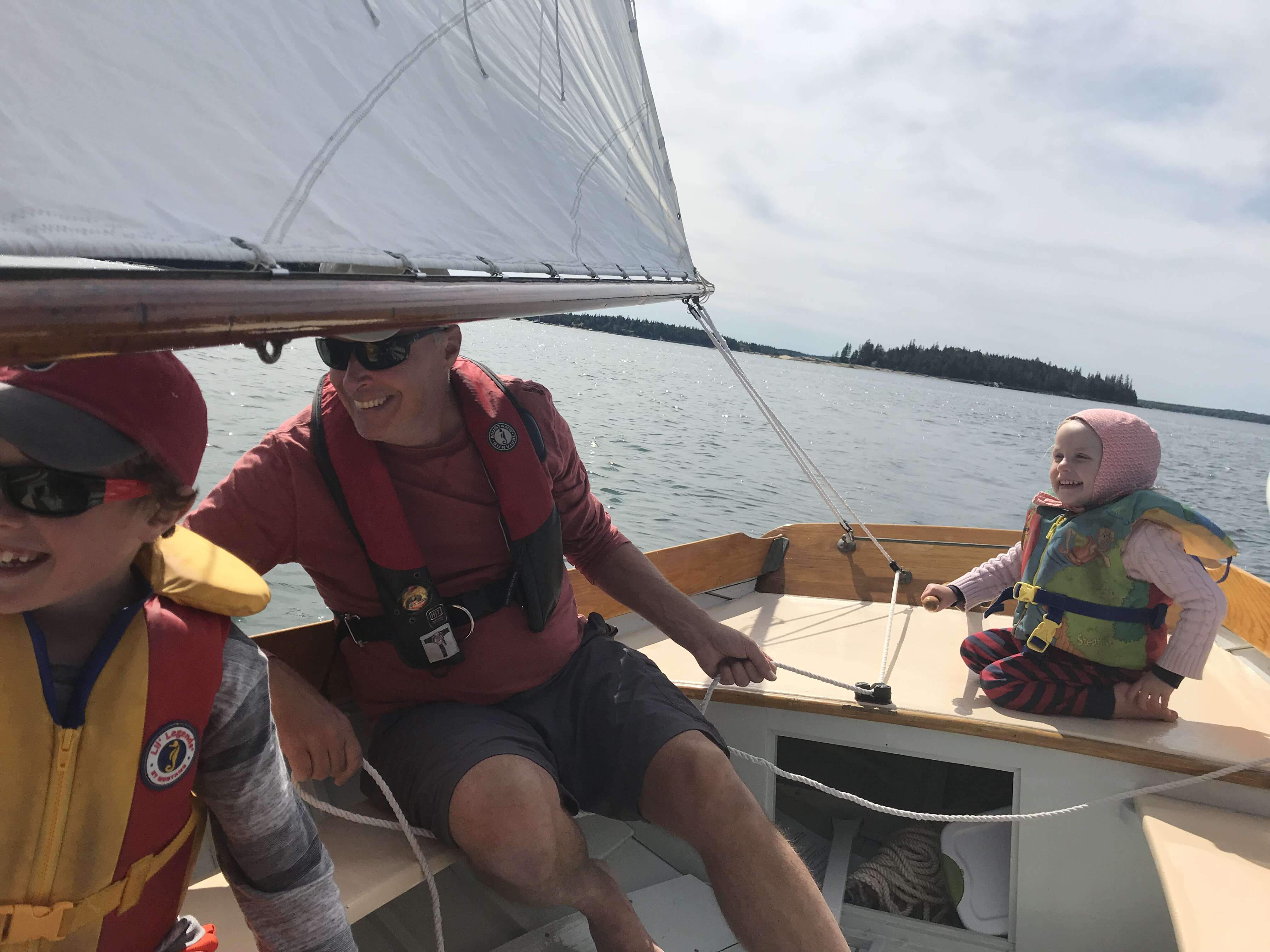 3 people sailing