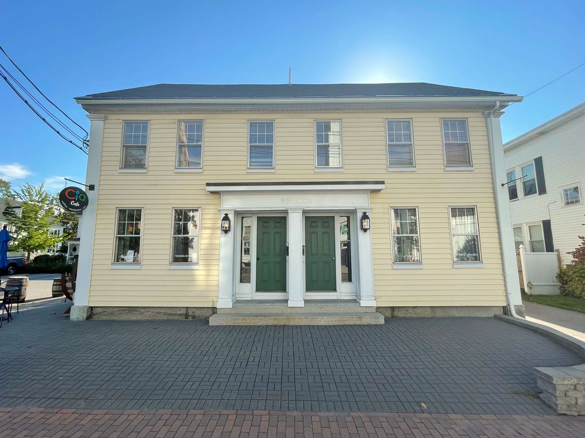 yellow building exterior with 2 doors