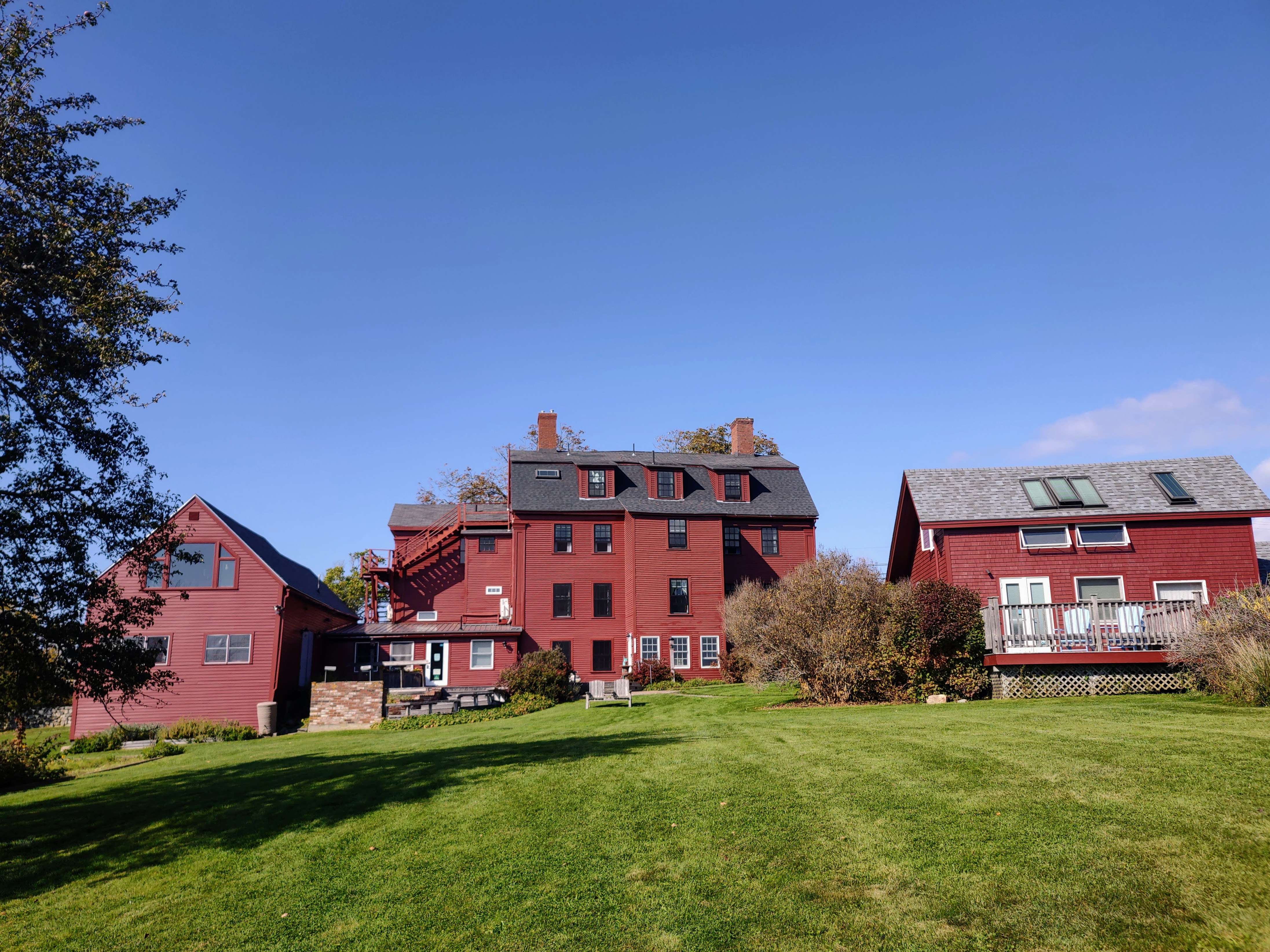 3 red buildings and lawn