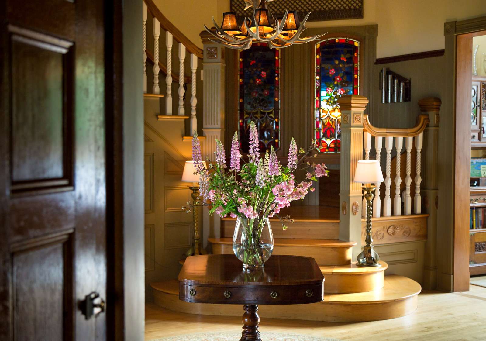 entry with stained glass windows and flowers