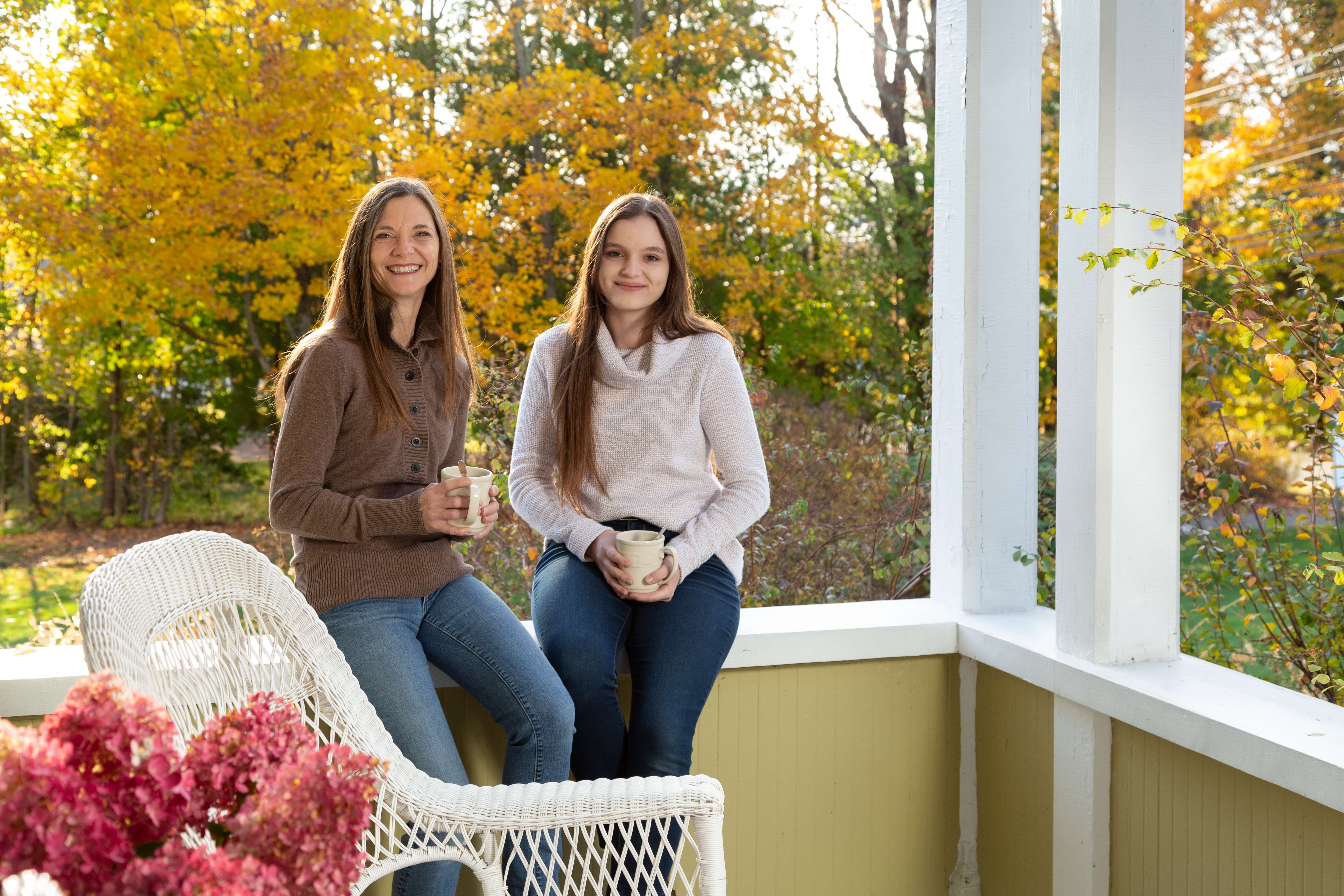 2 people smiling on porch