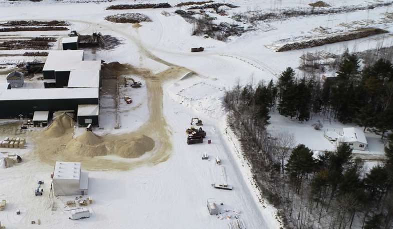 aerial of snowy land and buildings