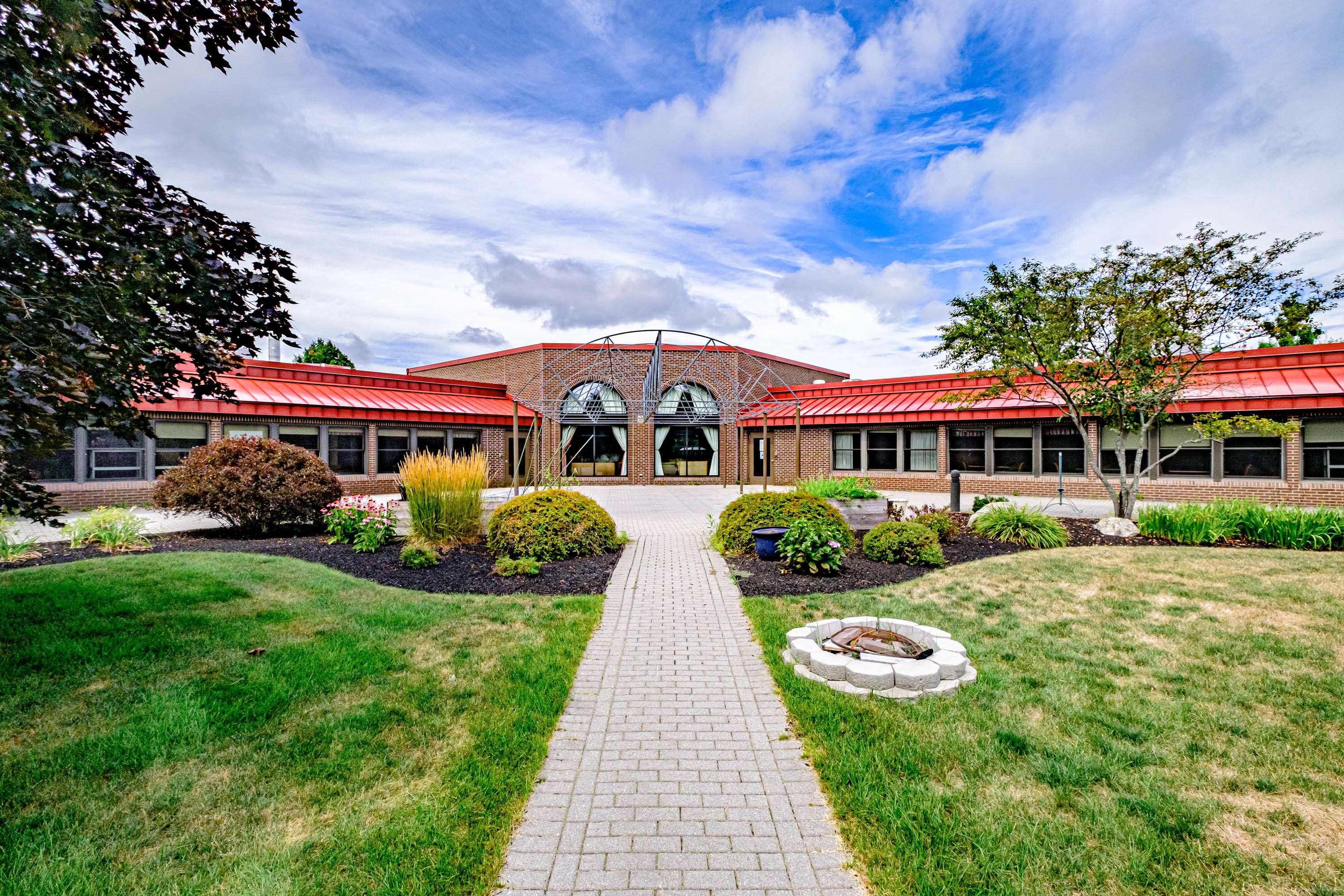 front entry with brick path and lawns