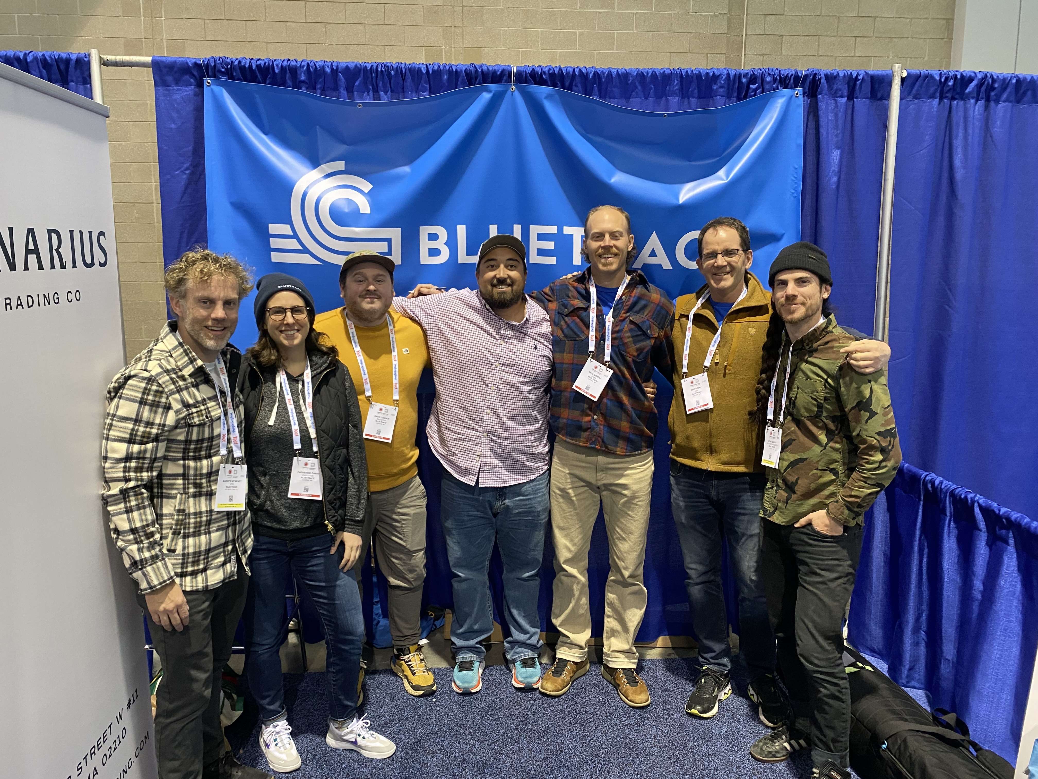 group of people standing in line in front of banner