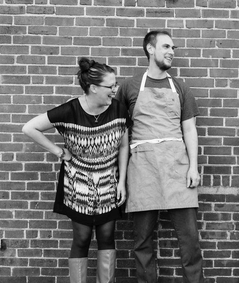 2 people in aprons smiling
