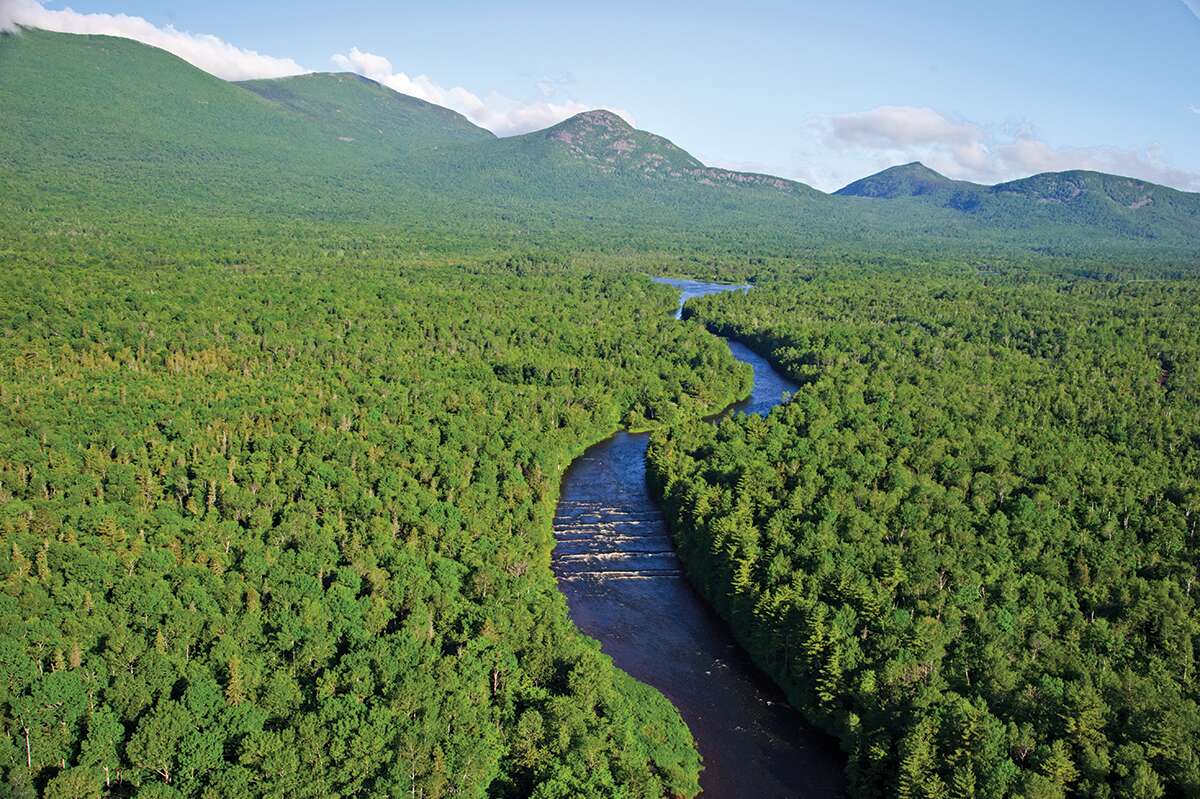 aerial of woods and river and hills