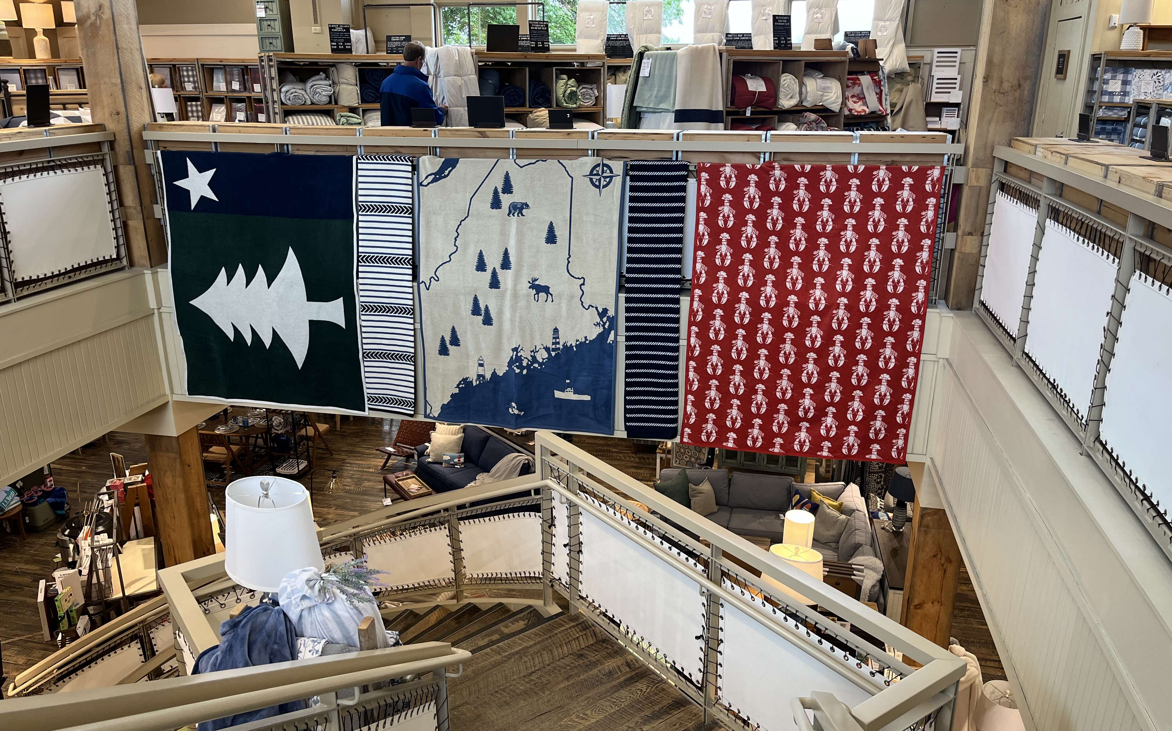 Store interior with blankets on display.
