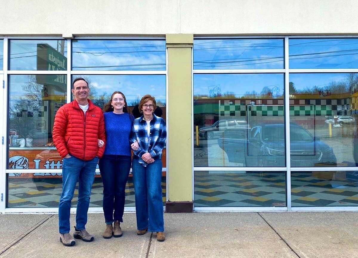 3 people in front of store