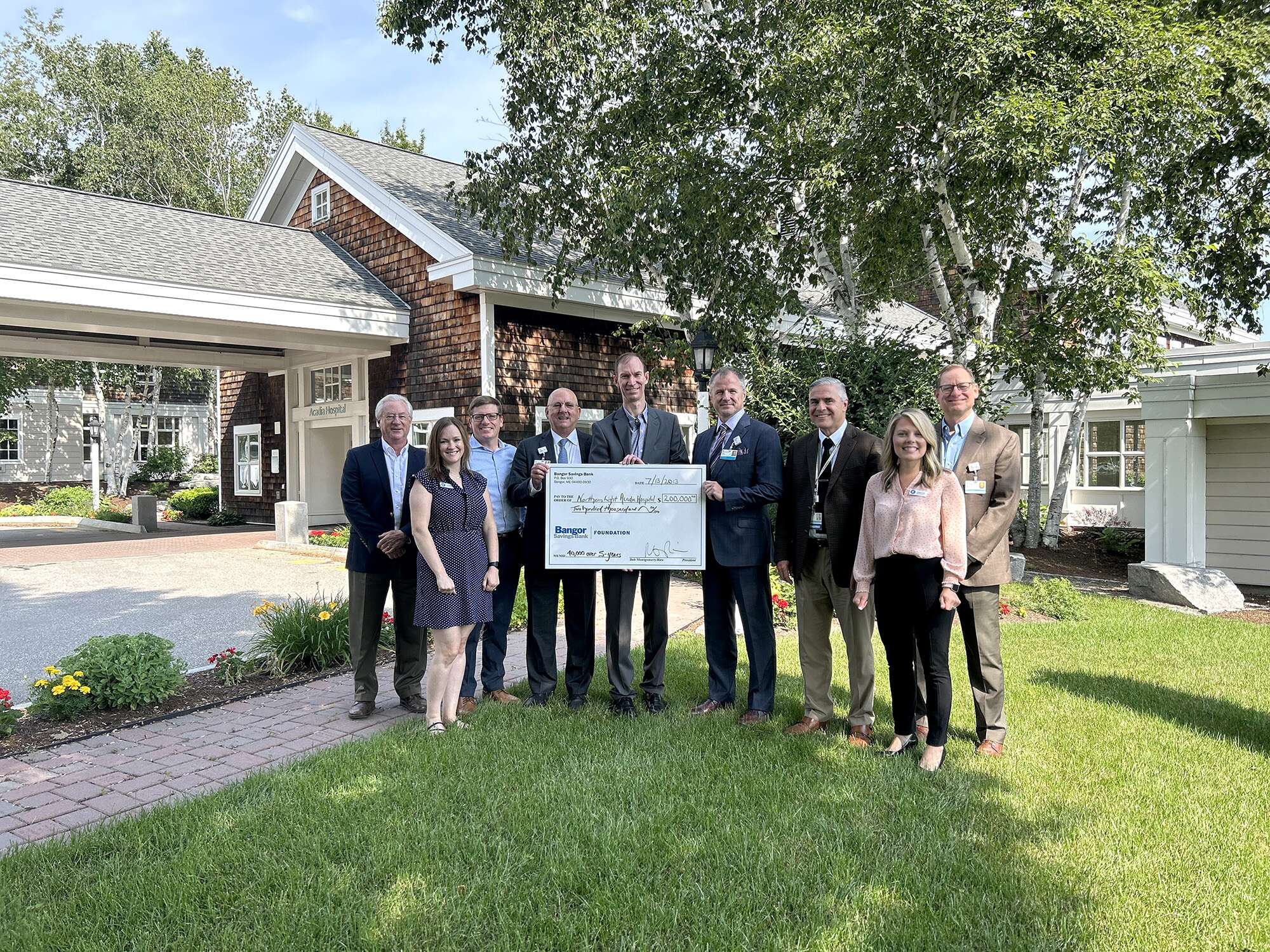 People holding oversized check