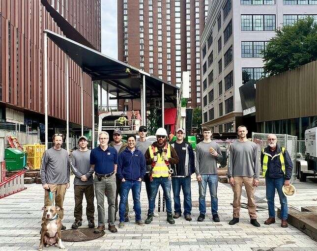 people lined up on city sidewalk