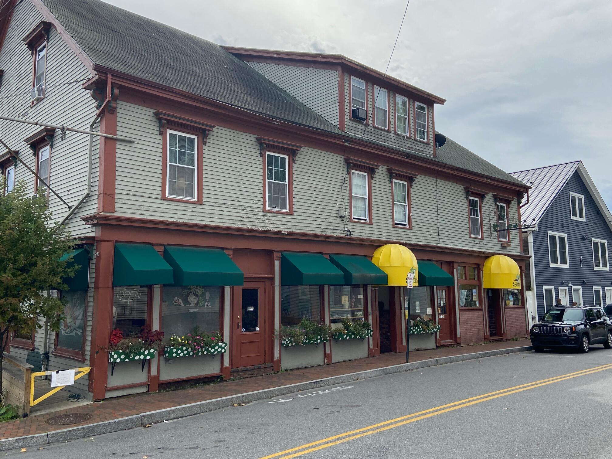 storefronts with road and car