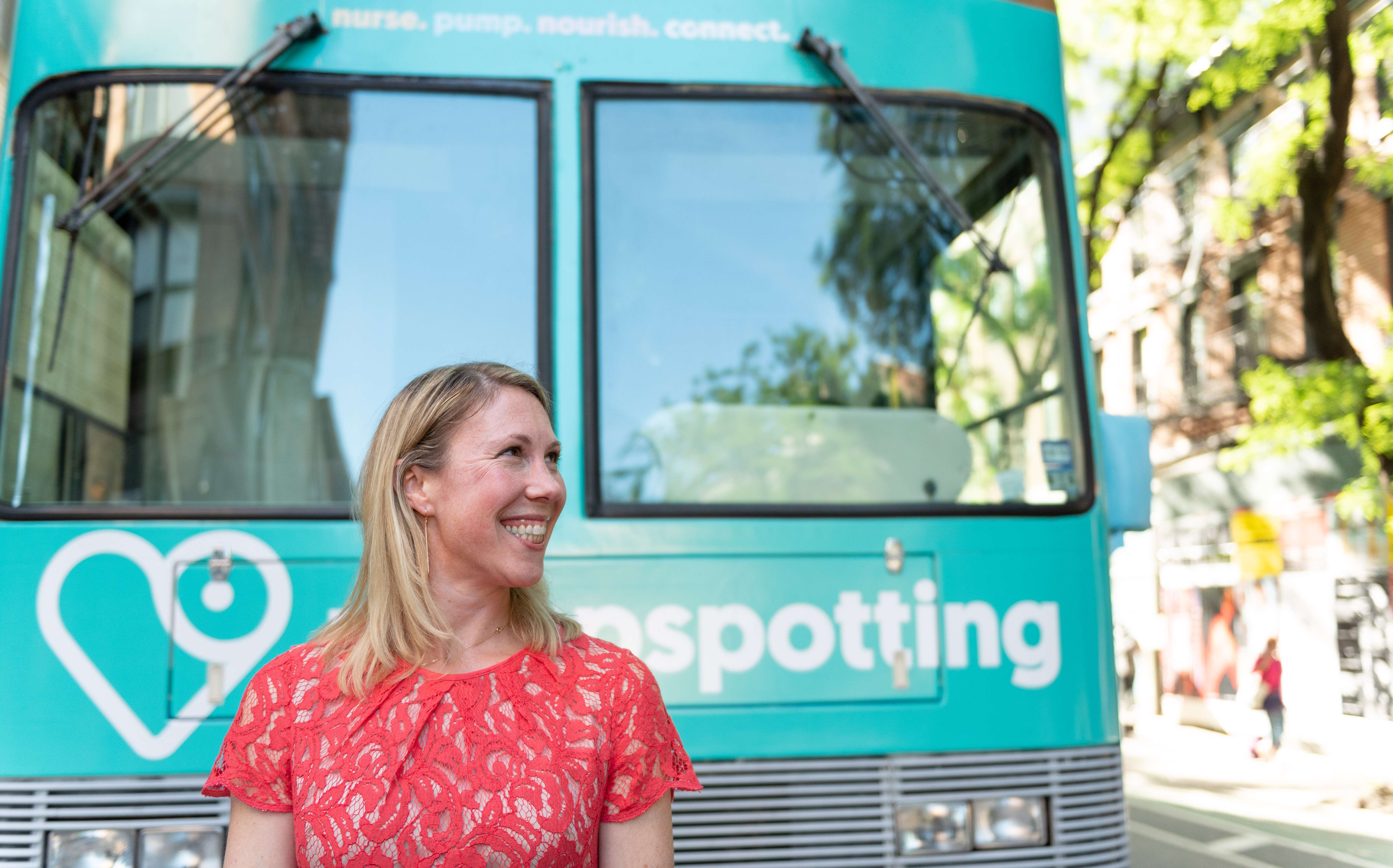 Amy Van Haren standing in front of pump spotting bus (teal color)