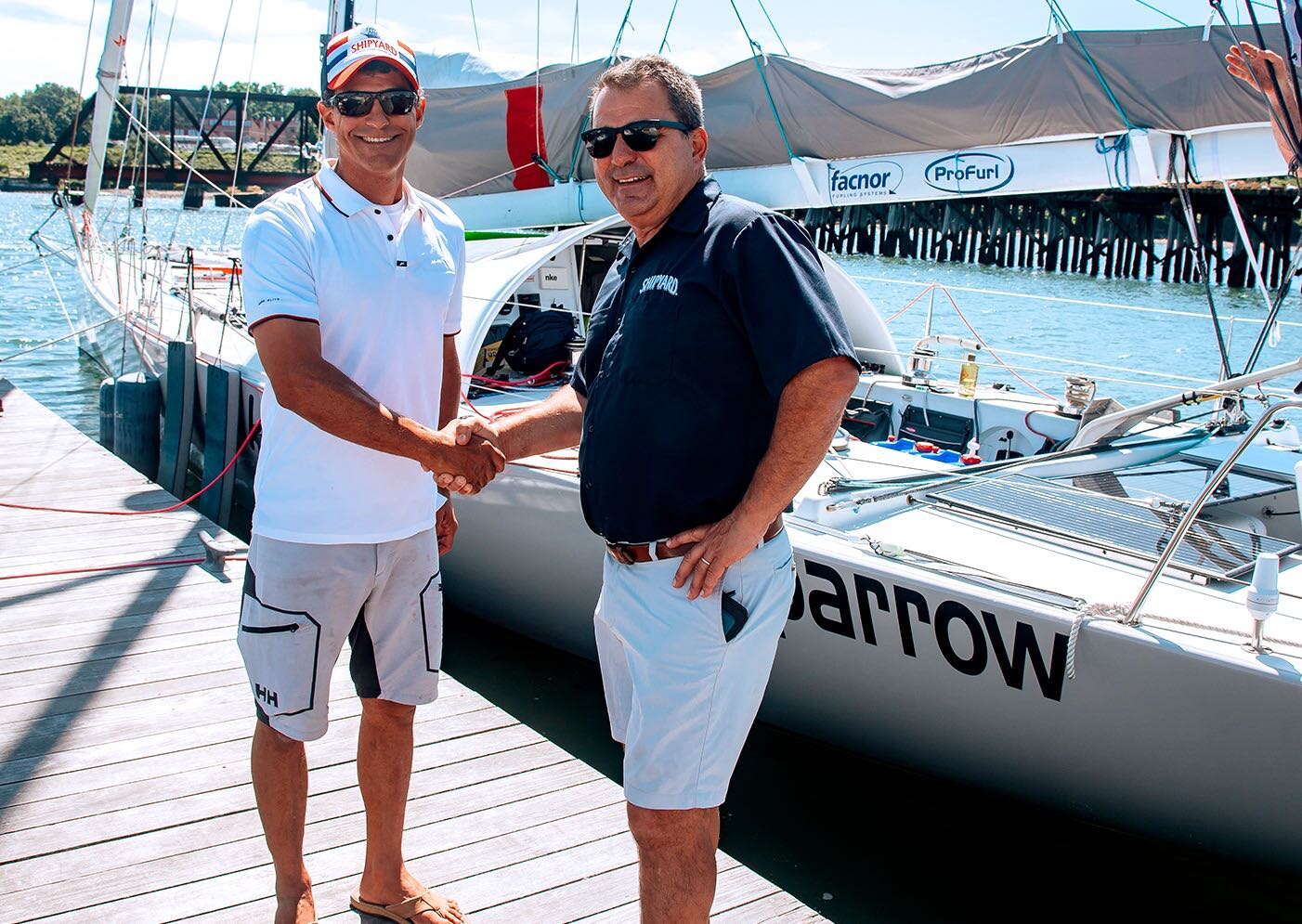 2 people with boat shaking hands