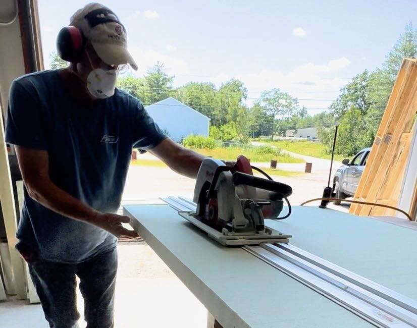 person with saw wearing mask
