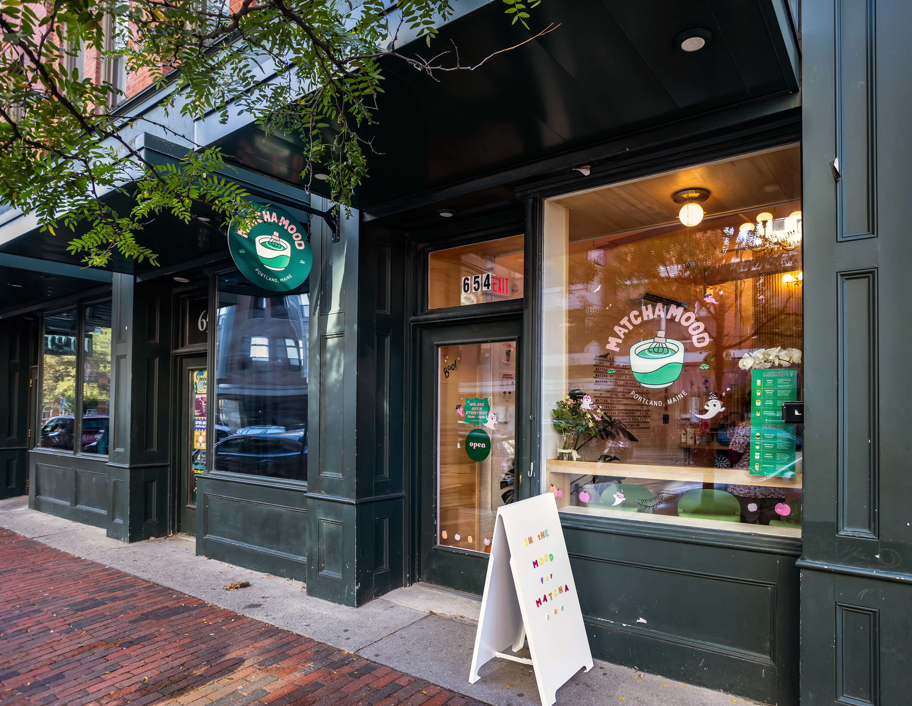 storefront with brick sidewalk and lights