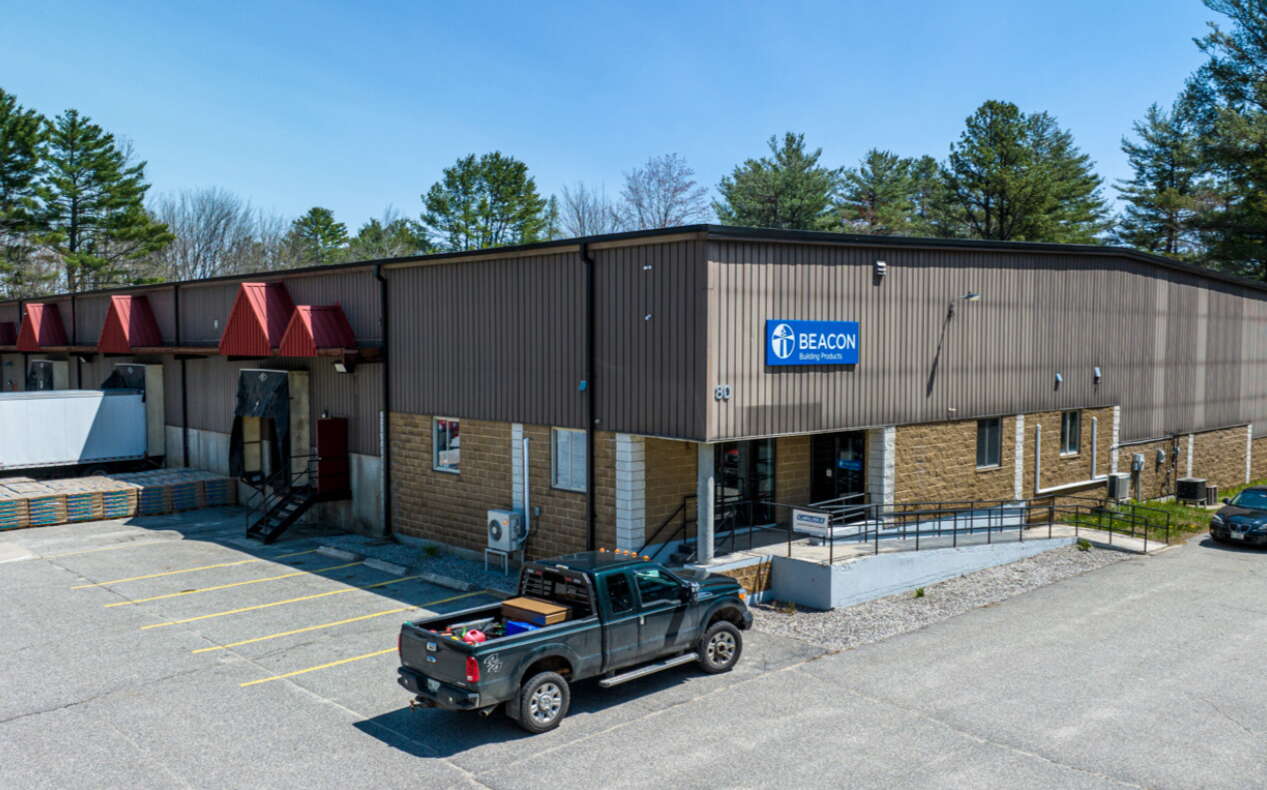 building withe vehicles and sign