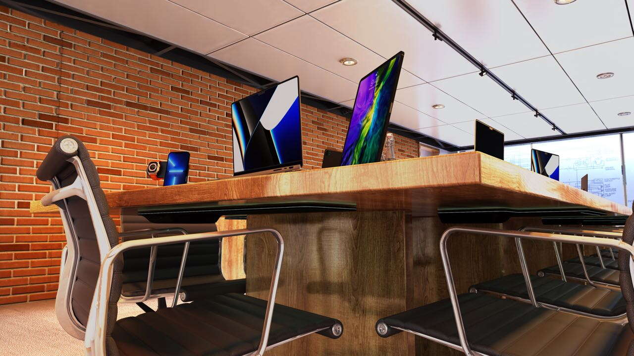 conference table, chairs, laptops, brick wall