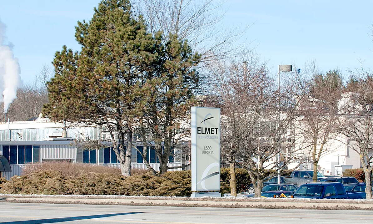 low building with trees and sign and cars