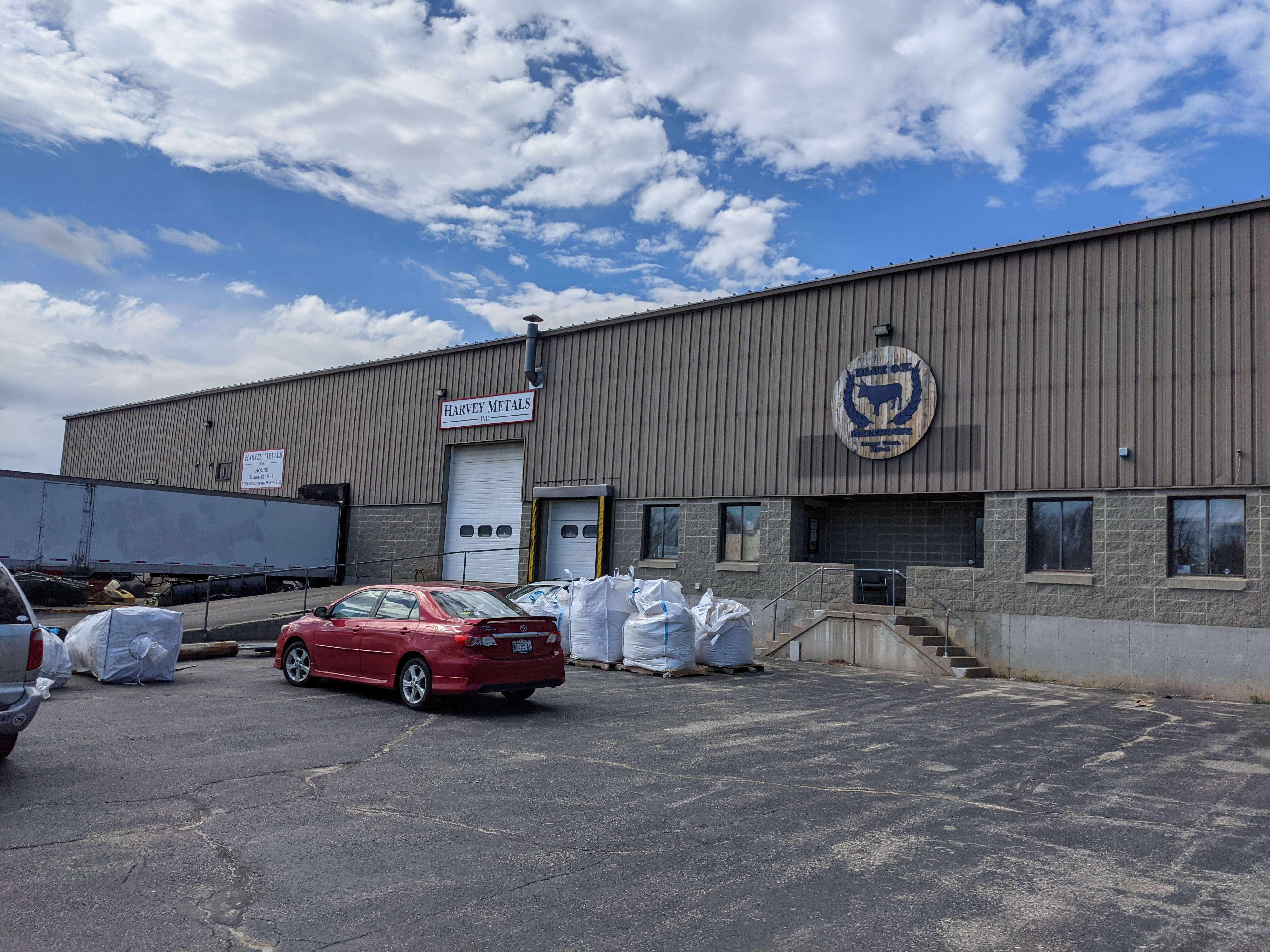 metal building with car and bags