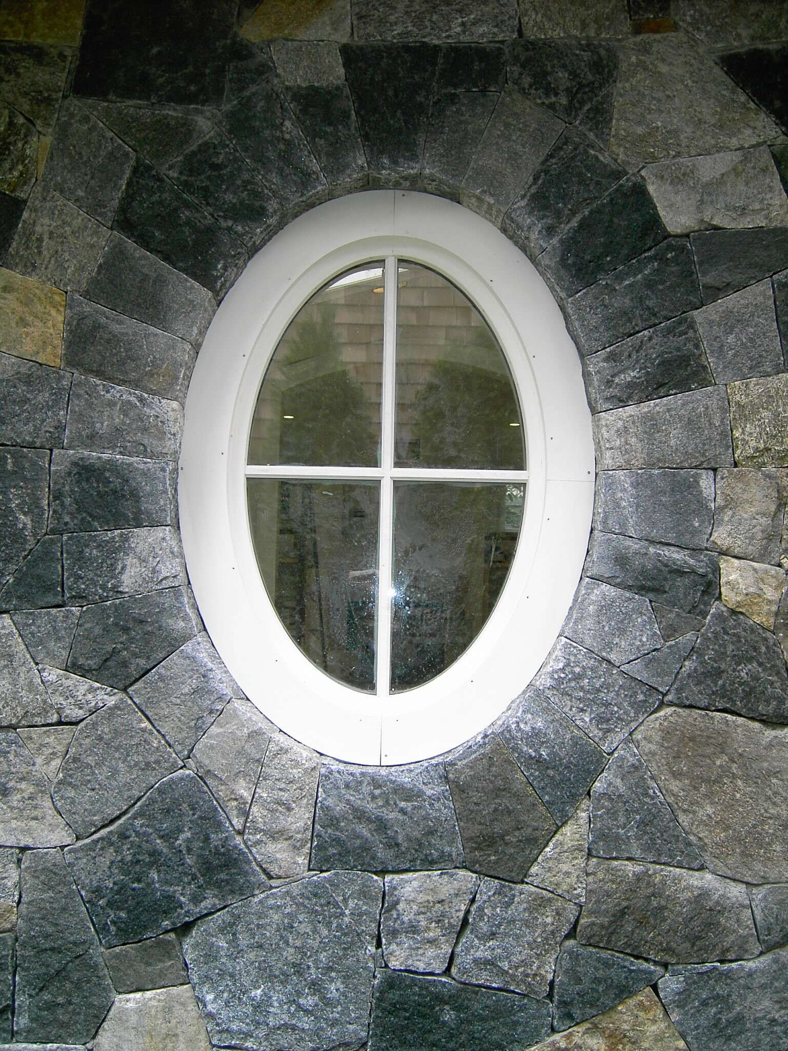 oval window surrounded by stone