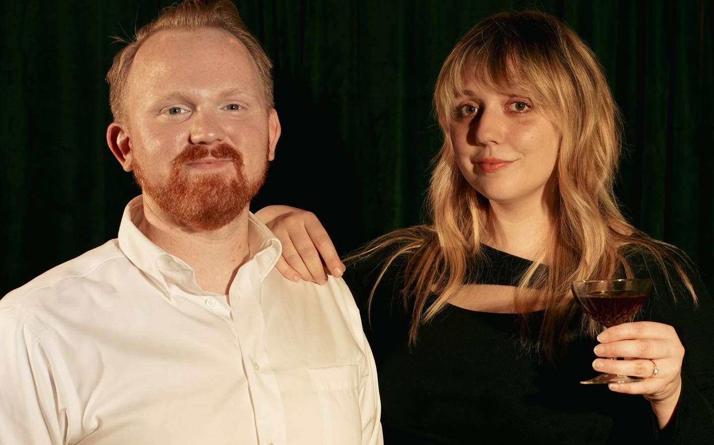 couple holding cocktail glasses