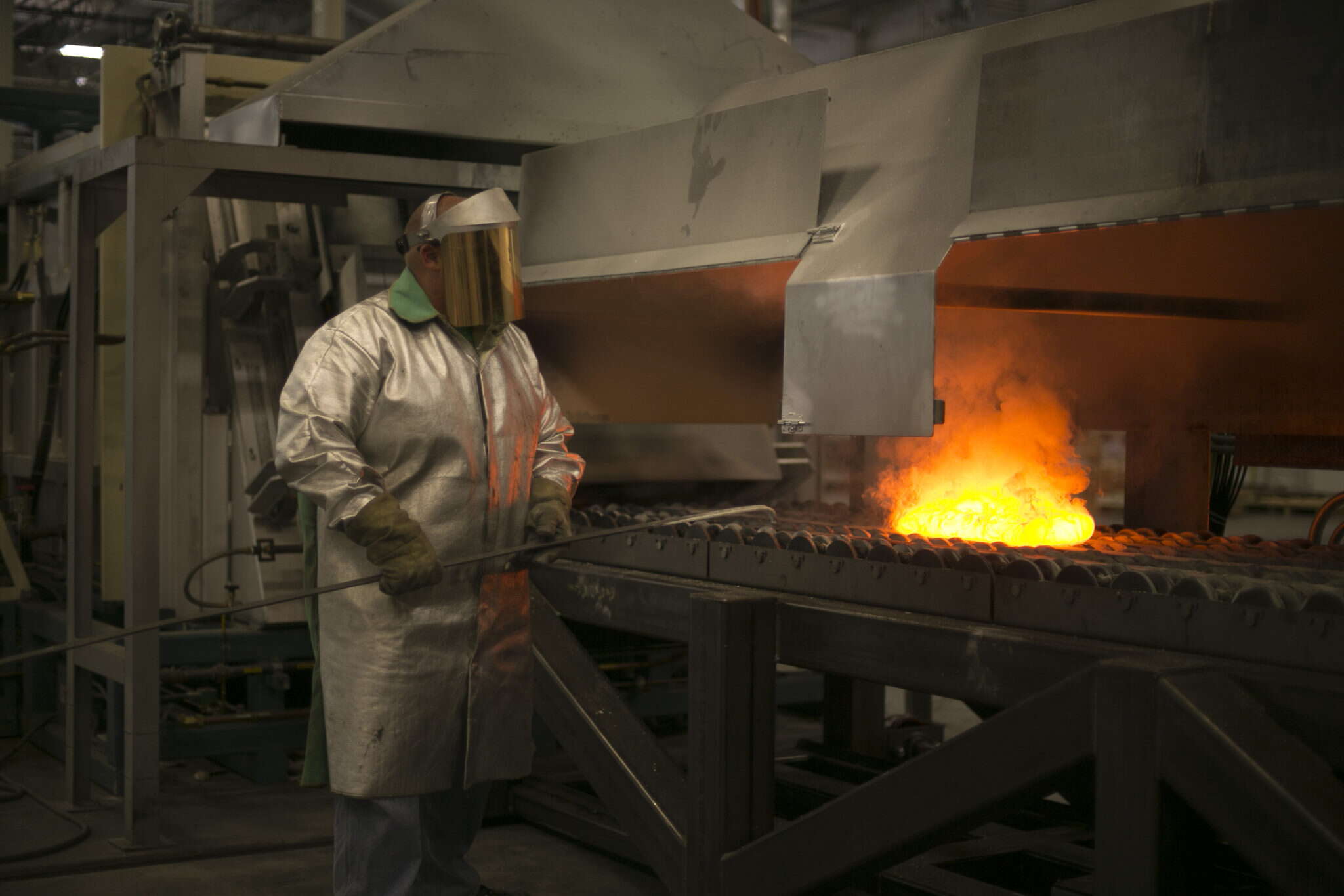 person in coat and shield with fire