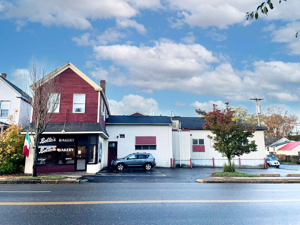 red and white building with window and cars