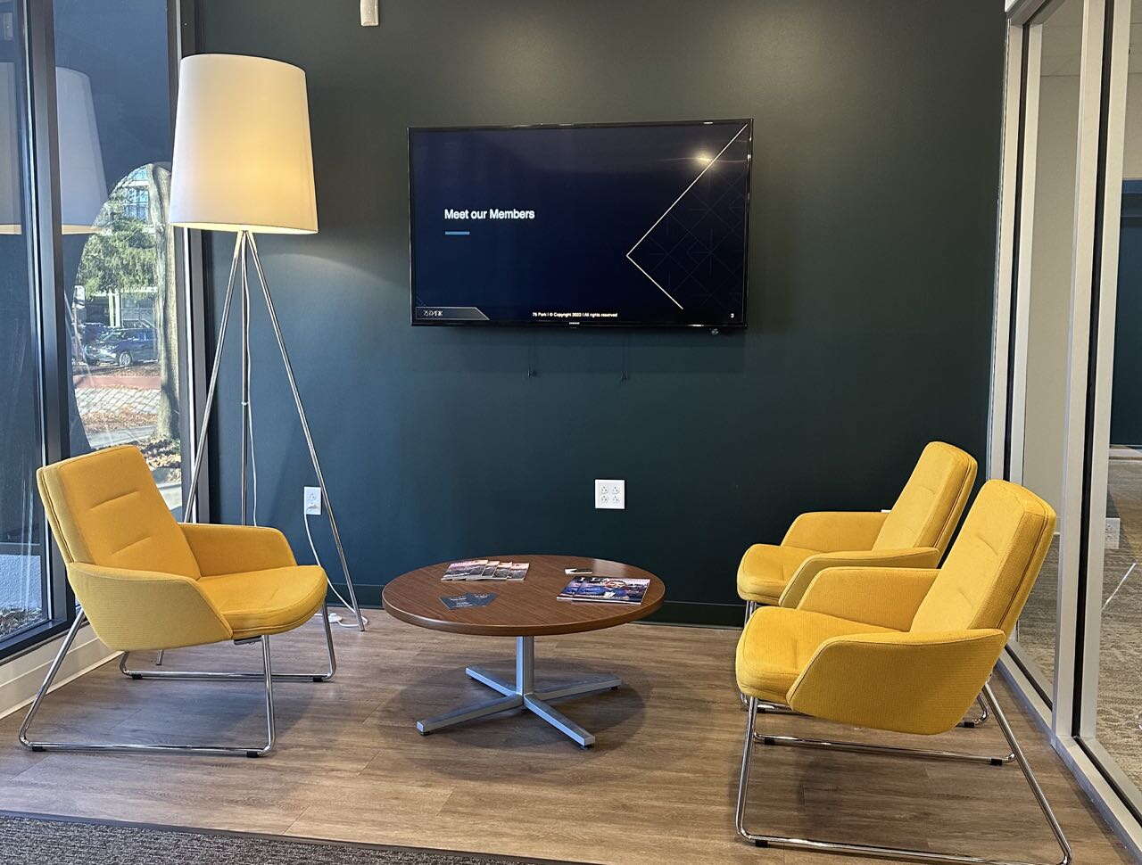 room with yellow chairs and round table