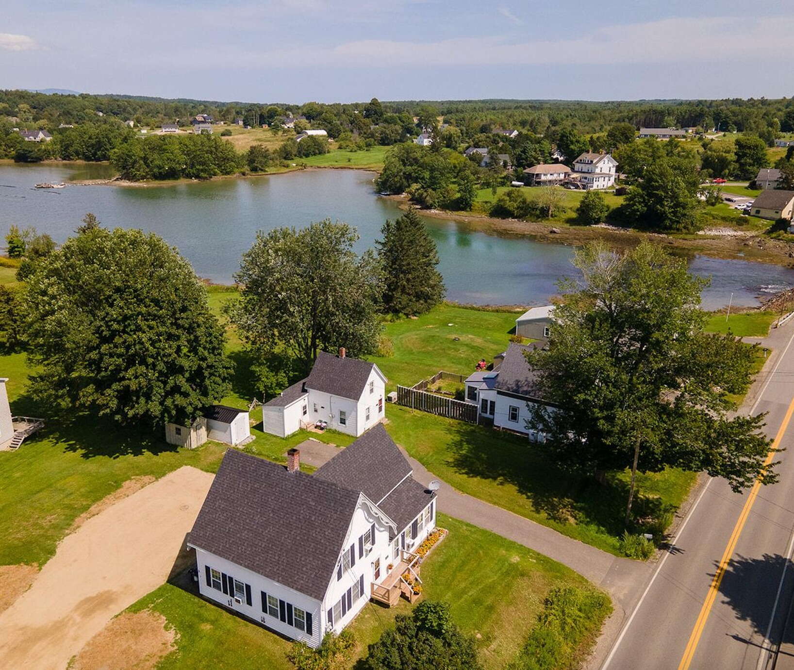 aerial of buildings lawns trees water