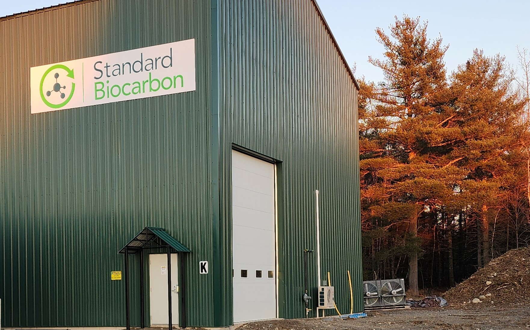 green metal building with sign