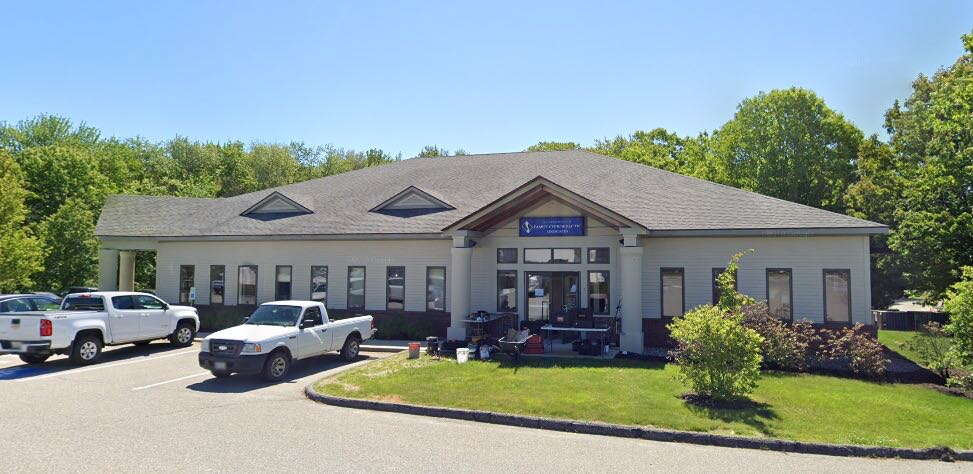 exterior of one-story building with vehicles